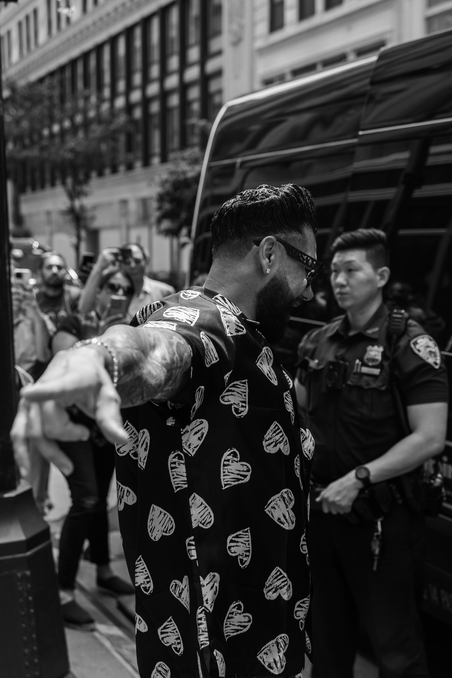 Pauly D reaches a hand straight toward the camera lens during a New York City appearance — candid moment photography by Brian Mullin, Pause Studios