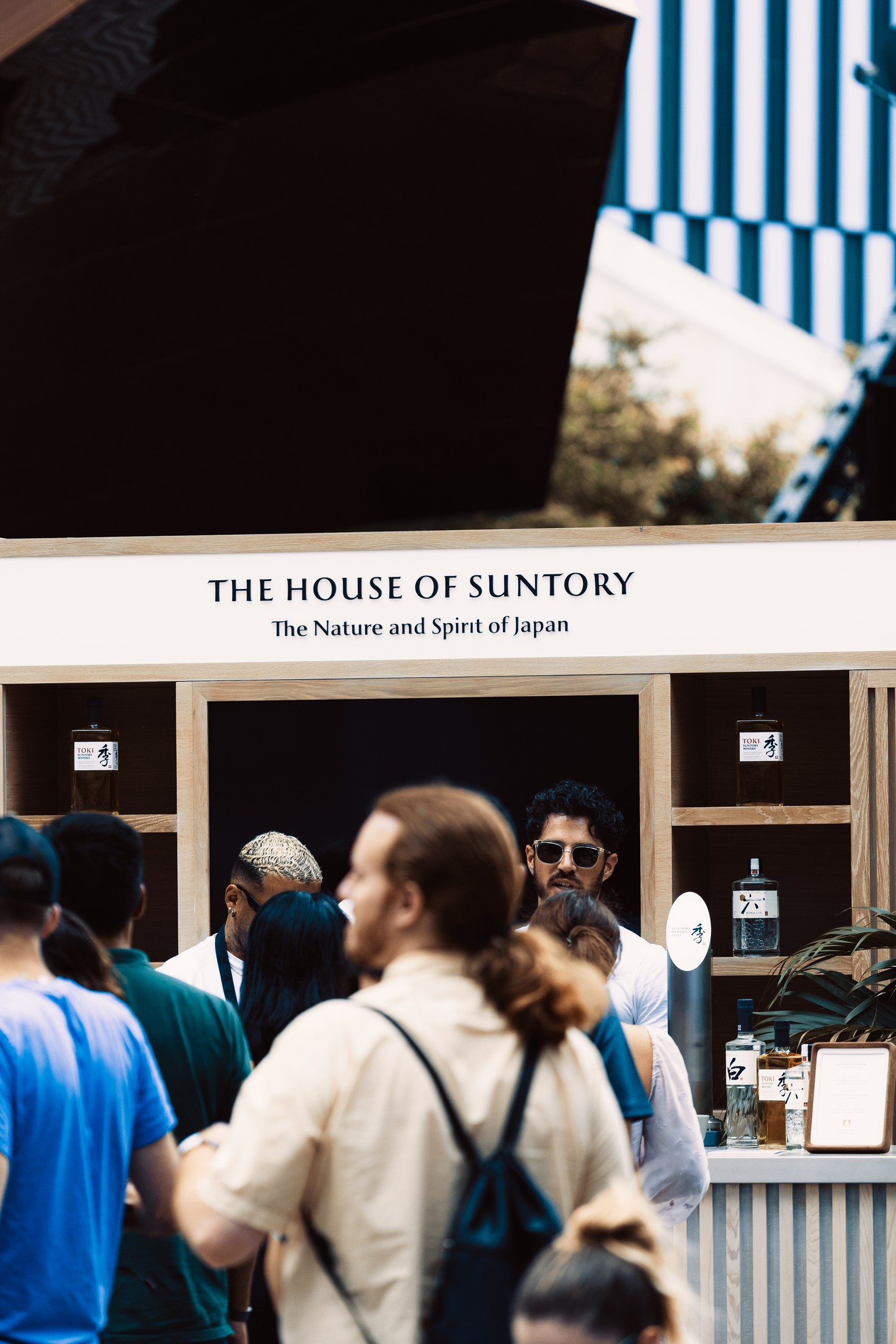 Guests at the House of Suntory brand-activation bar beneath the Vessel at Hudson Yards, NYC — candid commercial event photography by Brian Mullin, Pause Studios