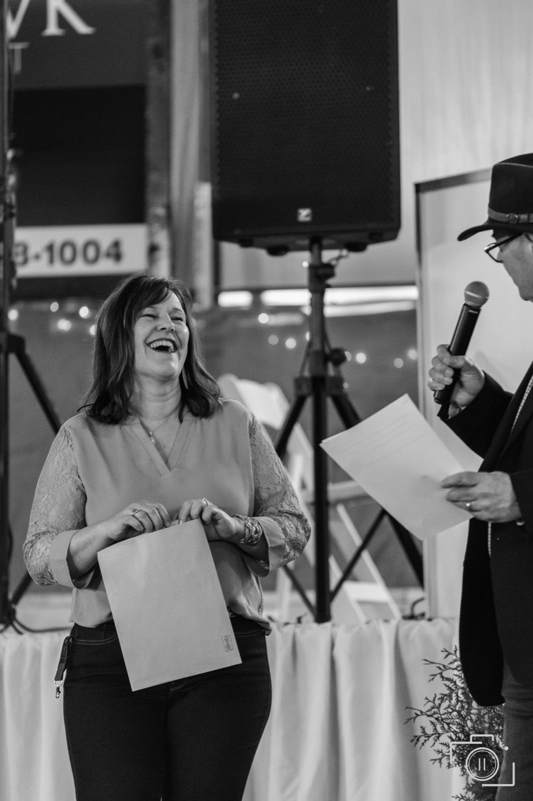 Award moment on stage during a gala program — the beat that anchors the recap. Pause Studios.