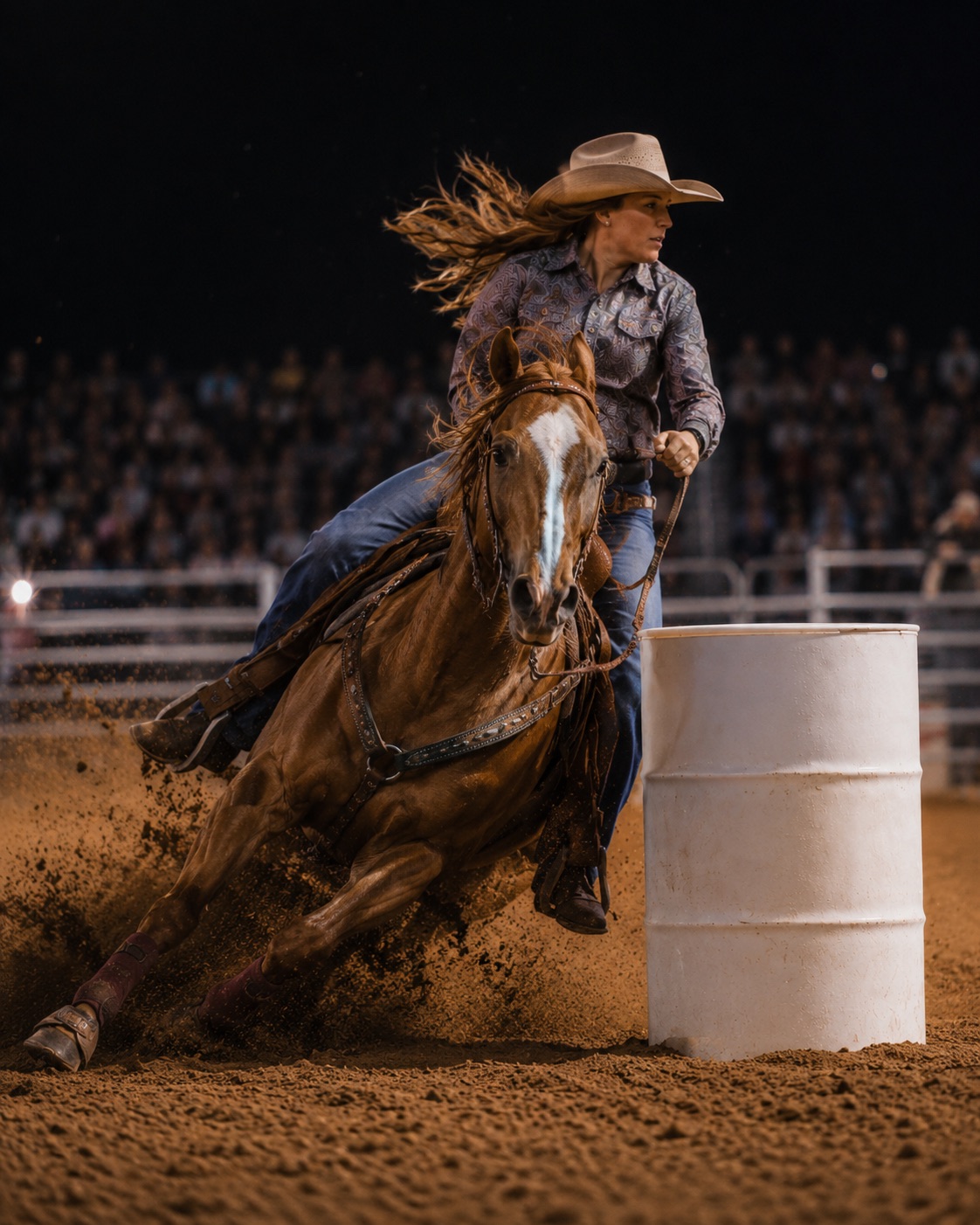 Barrel racer rounding the barrel at speed under arena lights — rodeo photography by Brian Mullin, Pause Studios.