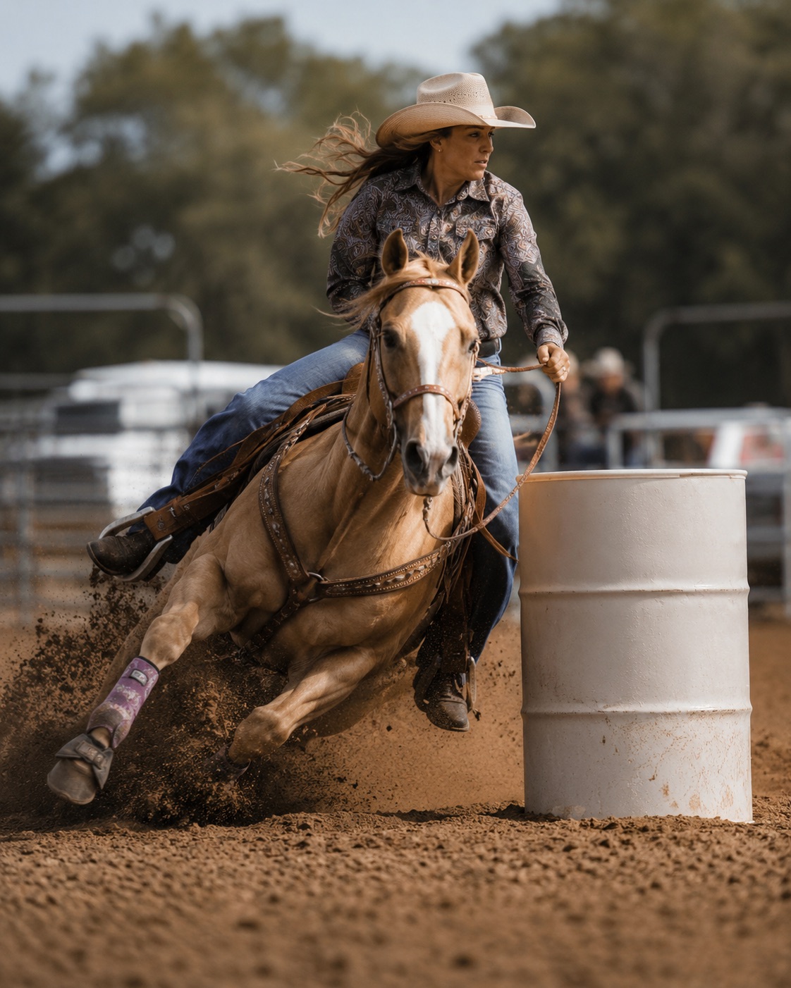 Barrel racer on a palomino leaning into the turn around the barrel in daylight — rodeo photography by Brian Mullin, Pause Studios.