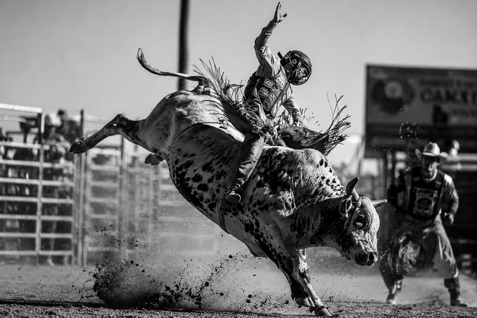 Bull rider at full extension mid-buck during a rodeo — western and rodeo event photography by Brian Mullin, Pause Studios.