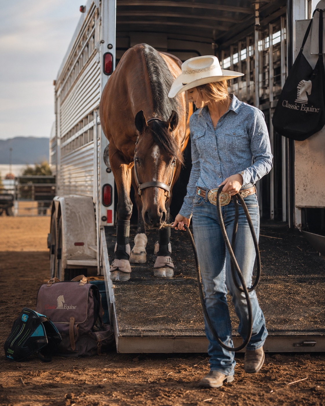 Rider leading a horse off the trailer at a rodeo in early light — equine event photography by Brian Mullin, Pause Studios.