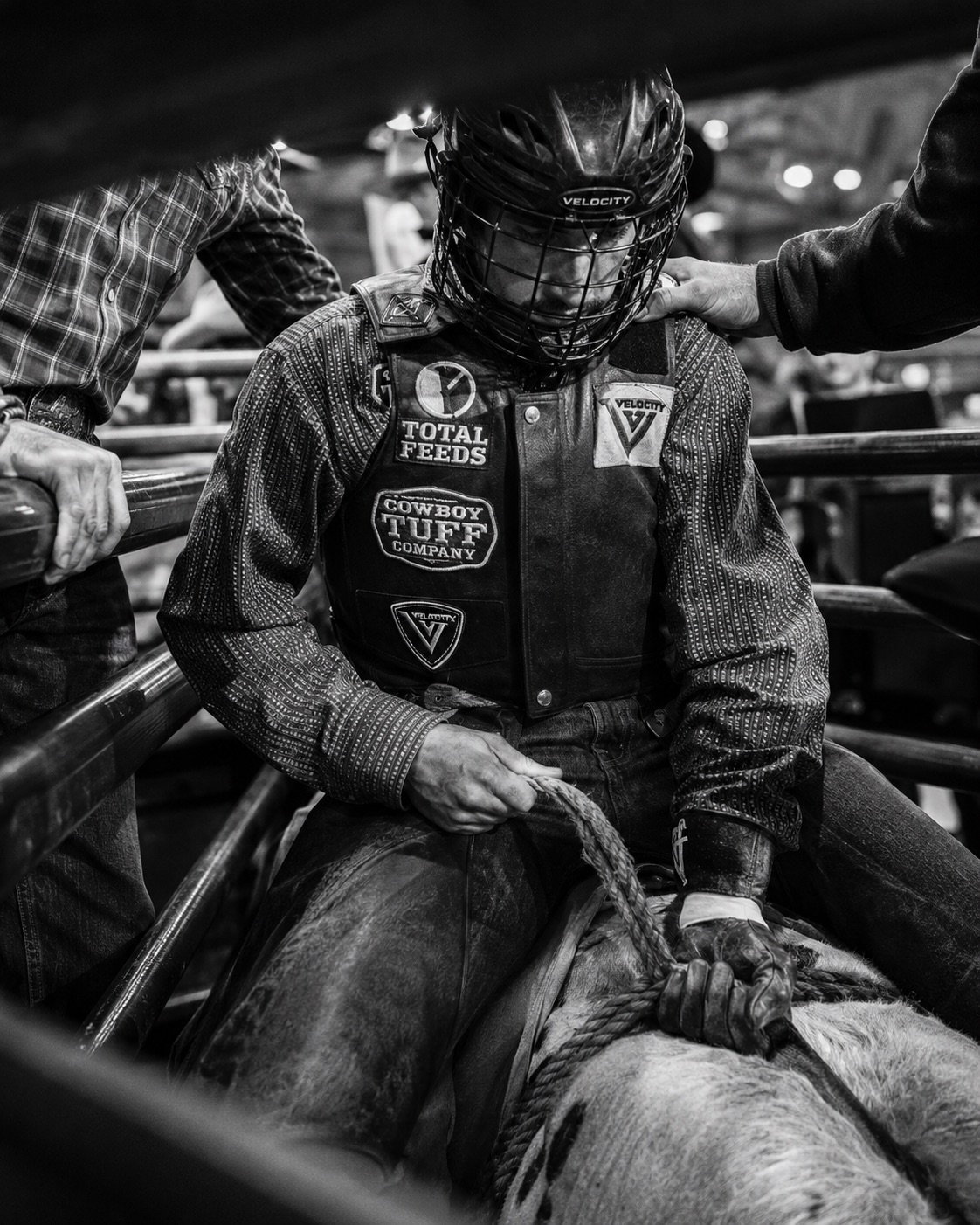Bull rider's protective vest and rope gear in the chute, close detail in black and white — rodeo photography by Brian Mullin, Pause Studios.