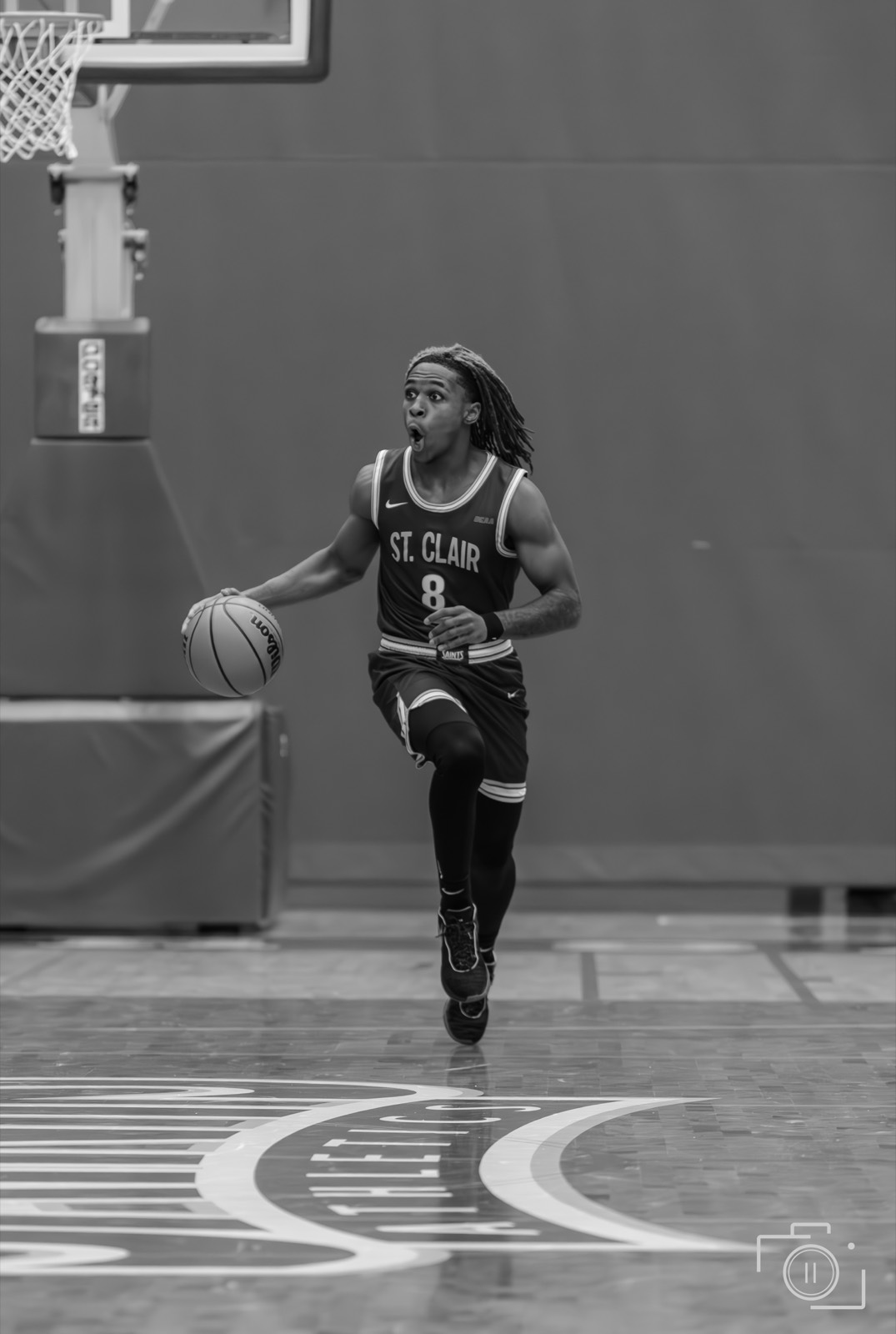 A player driving with the ball in black and white. Pause Studios.