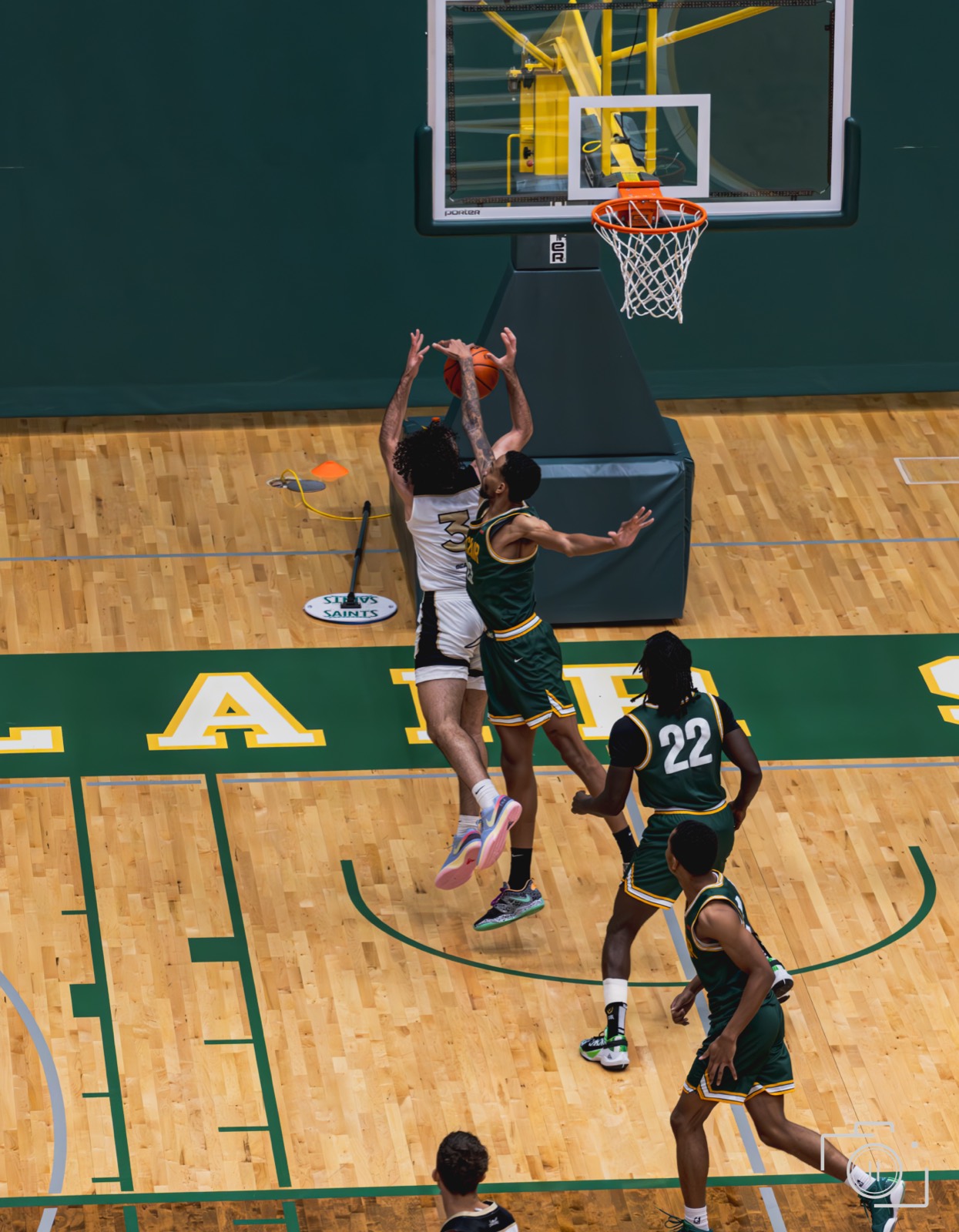 A player rising for a layup during a streetball game, in color. Pause Studios.