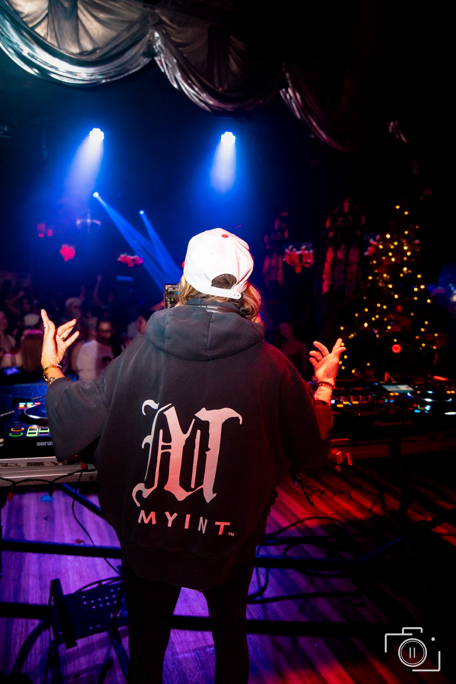 DJ performing at a premium live event, blue stage lighting, ornate venue ceiling — event photography by Brian Mullin, Windsor Ontario
