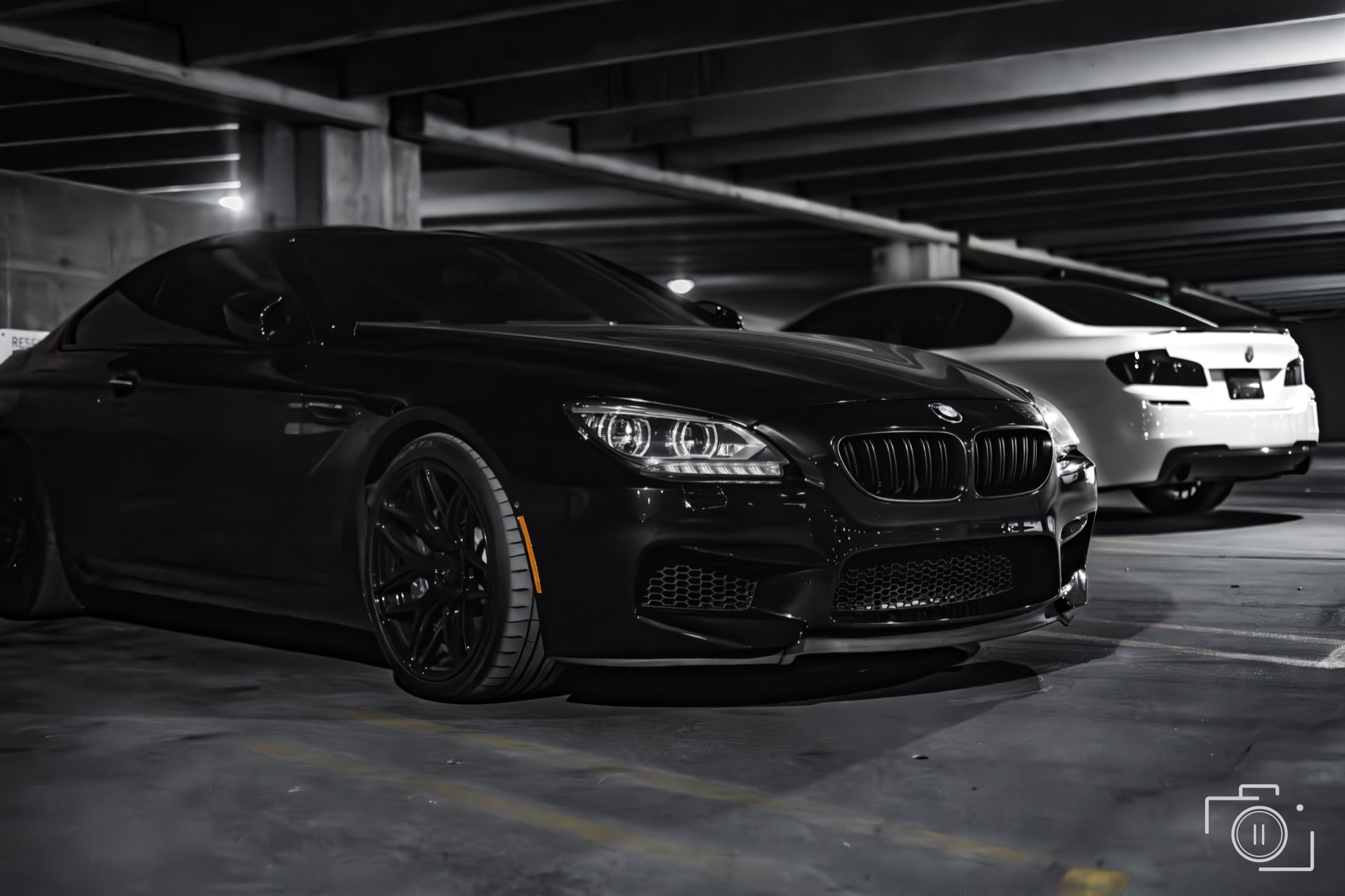 BMW M6 paired with a second vehicle in a garage setting, Southfield, Michigan. Personal automotive editorial. Photography by Brian Mullin, Pause Studios.