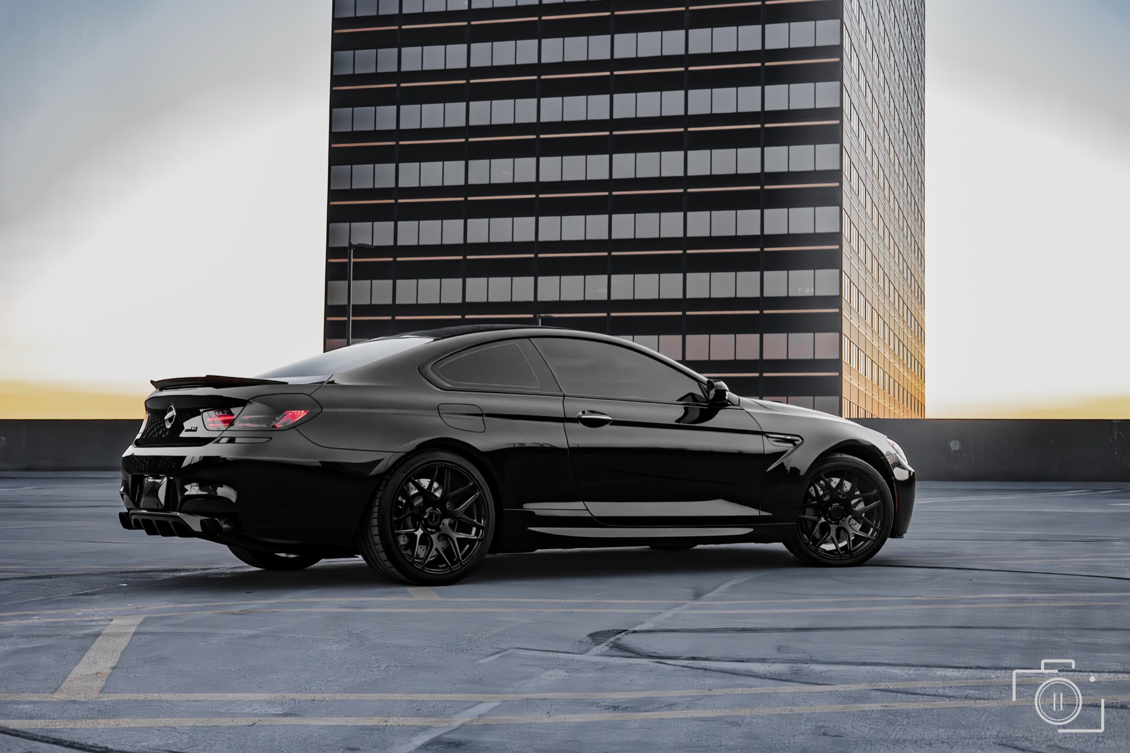 BMW M6 profile against the Metro Detroit skyline, photographed in Southfield, Michigan. Personal automotive editorial. Photography by Brian Mullin, Pause Studios.