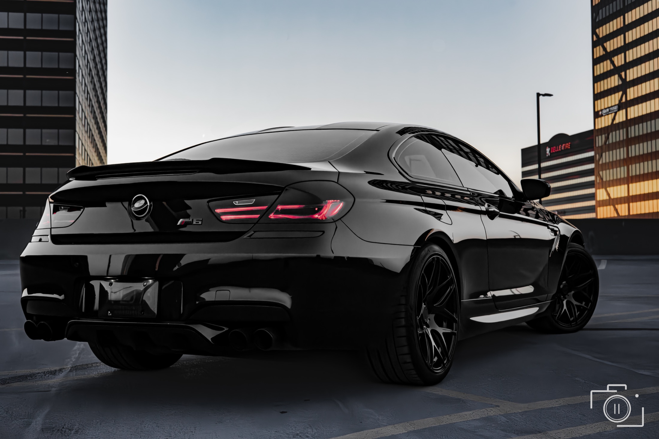 BMW M6 rear three-quarter against the Metro Detroit skyline, photographed in Southfield, Michigan. Personal automotive editorial. Photography by Brian Mullin, Pause Studios.