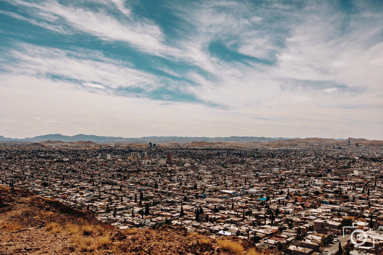 The city of Chihuahua sprawling toward the desert mountains, northern Mexico — destination editorial photography by Brian Mullin, Pause Studios.
