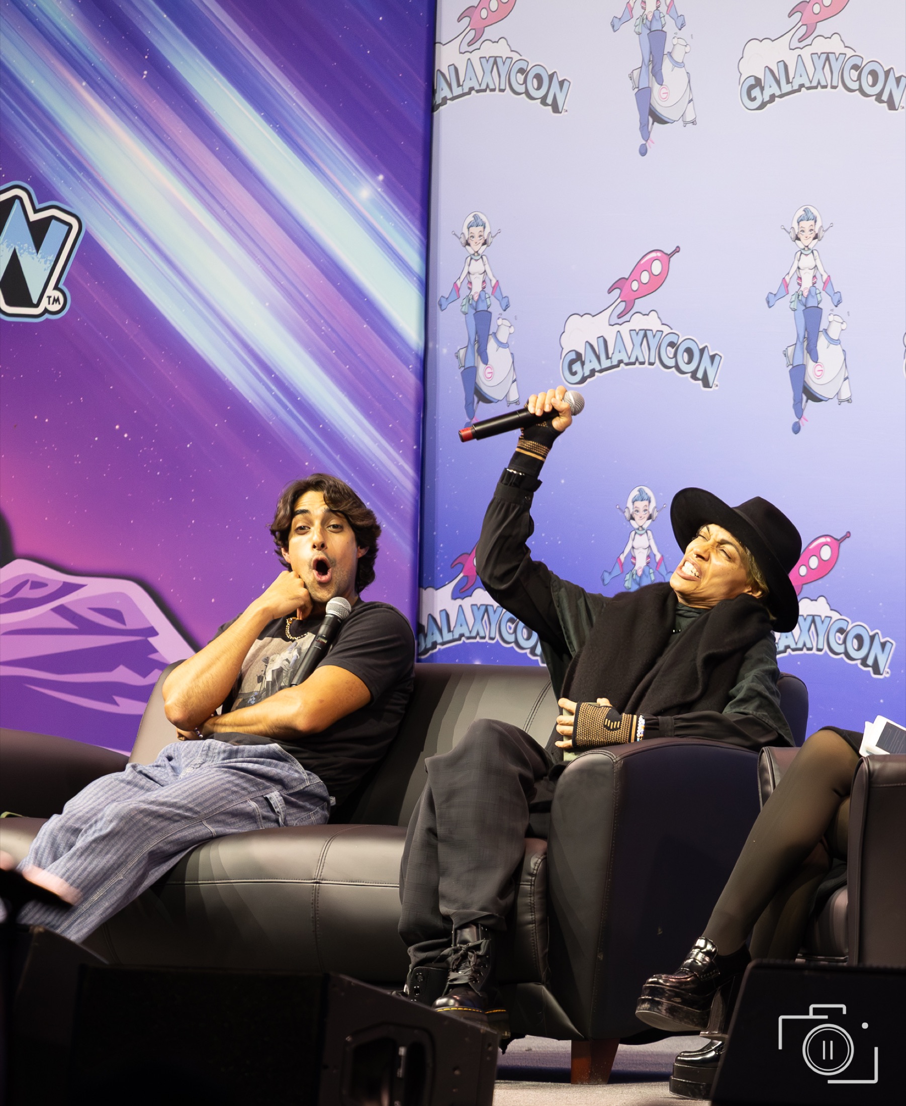 Eman Esfandi and Rosario Dawson at a Galaxy Con Columbus panel, candid moment on stage