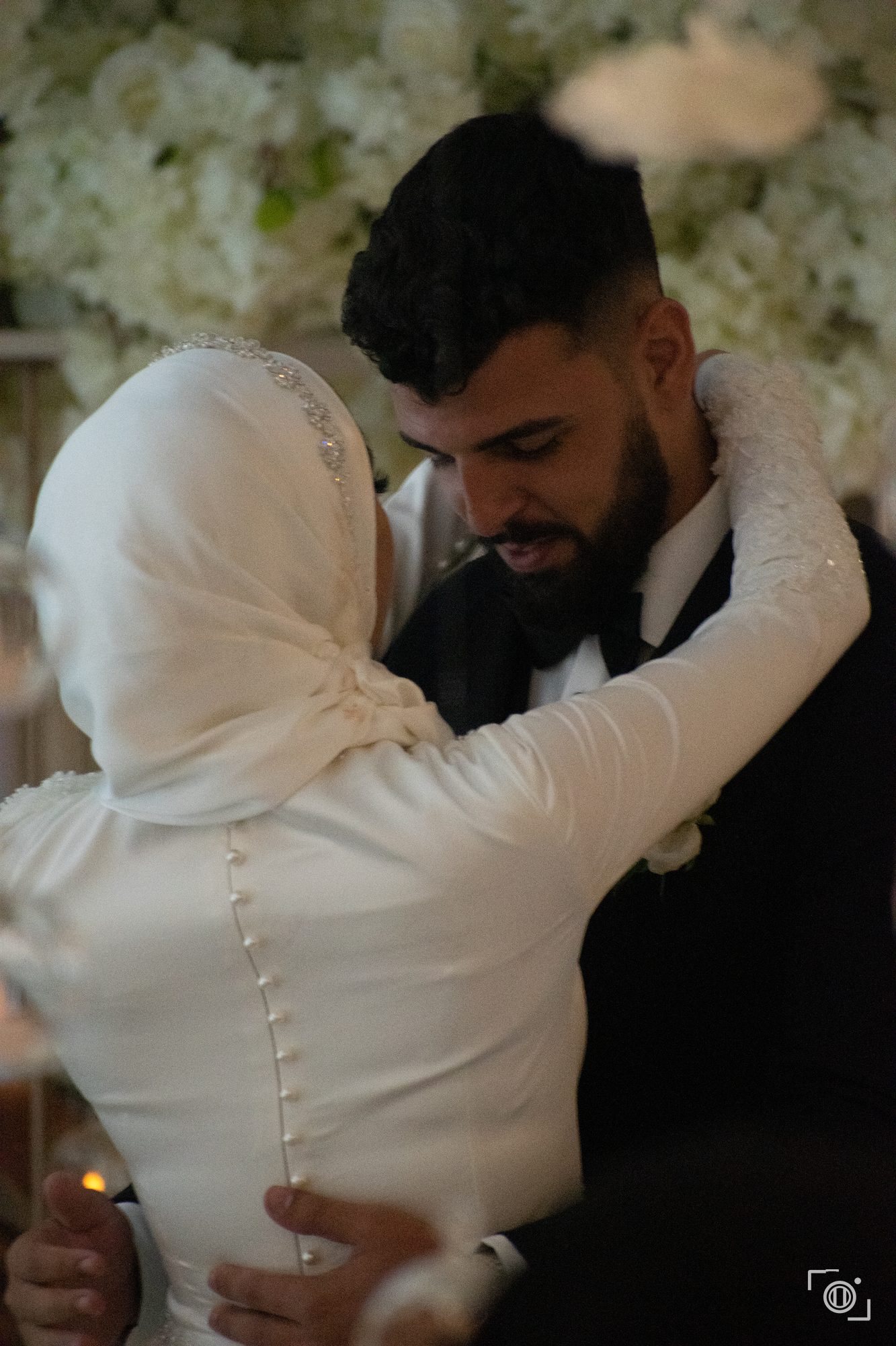 Groom holds the bride close in warm light. Intimate wedding coverage, Pause Studios.