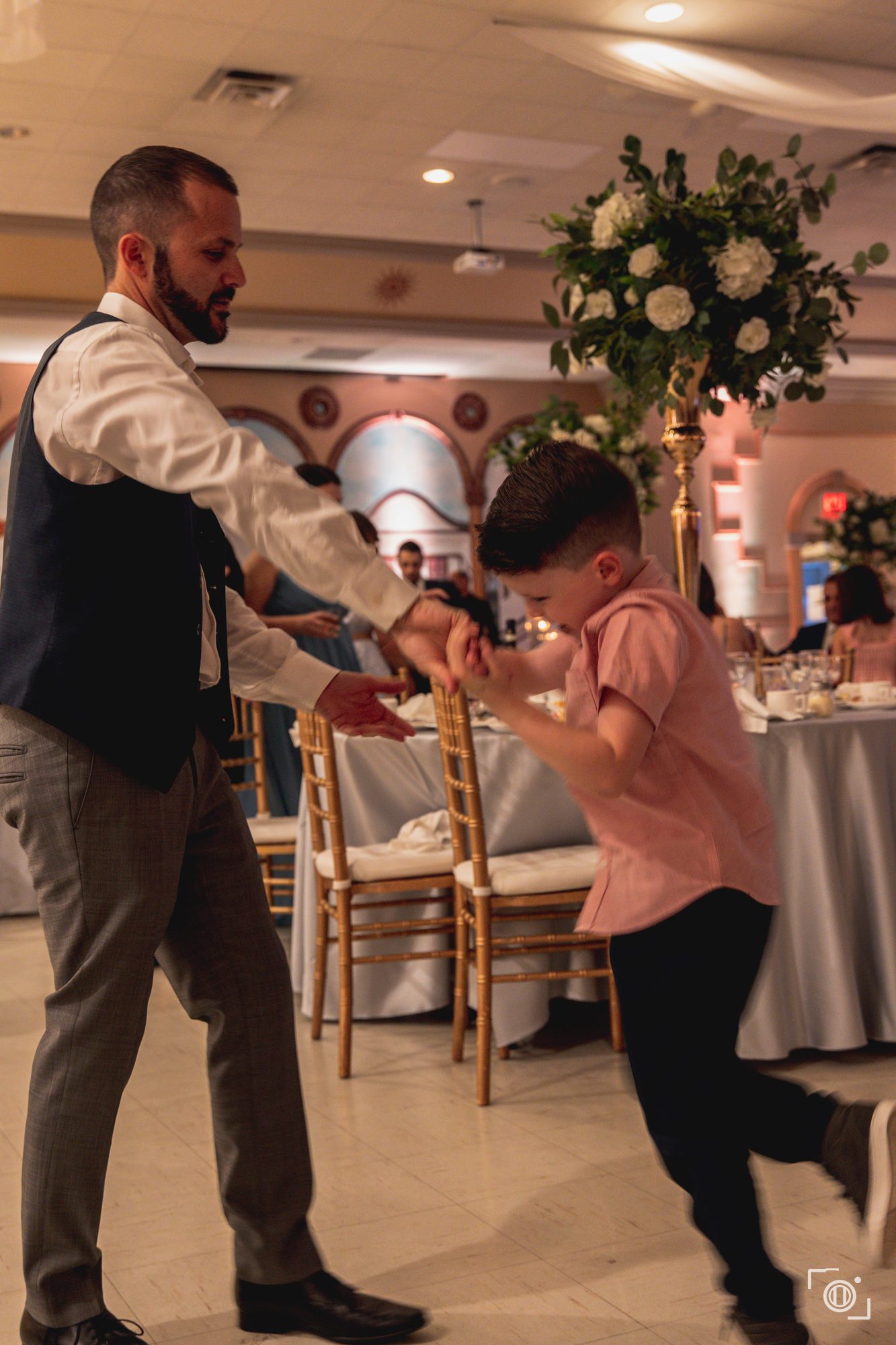 Guest mid-move on a packed dance floor. Candid wedding reception coverage, Pause Studios.