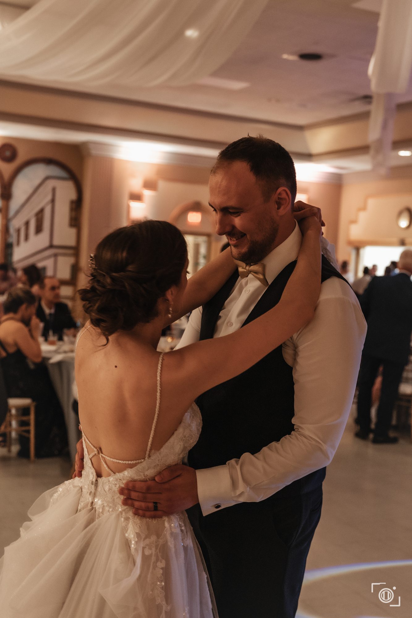Couple's first dance, holding each other on the floor. Wedding reception photography by Brian Mullin, Pause Studios.